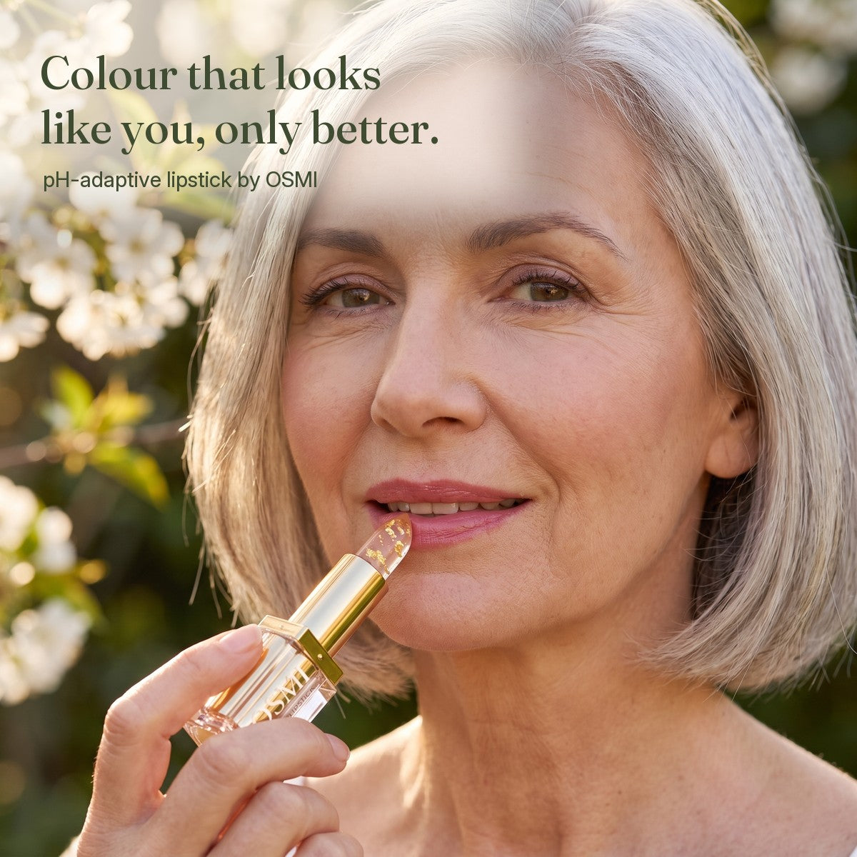 Woman applying OSMI Aura Lipstick