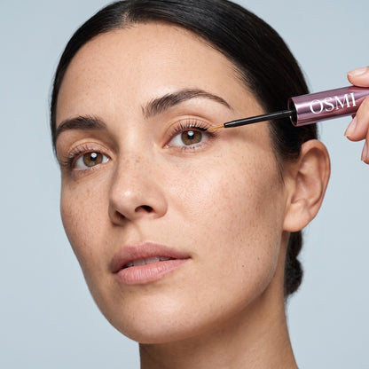 Applying OSMI Lash Serum along the upper lash line